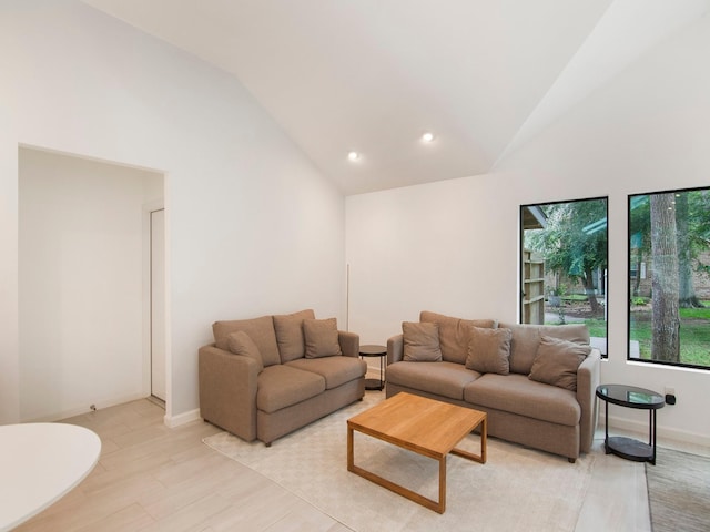 2812 Crossvine, The Woodlands, TX 77380 - living room featuring high vaulted ceiling, light wood-style flooring, and recessed lighting