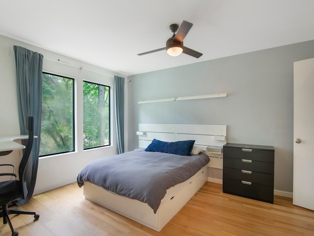 2812 Crossvine, The Woodlands, TX 77380 - bedroom featuring light wood-style floors, a desk, and ceiling fan