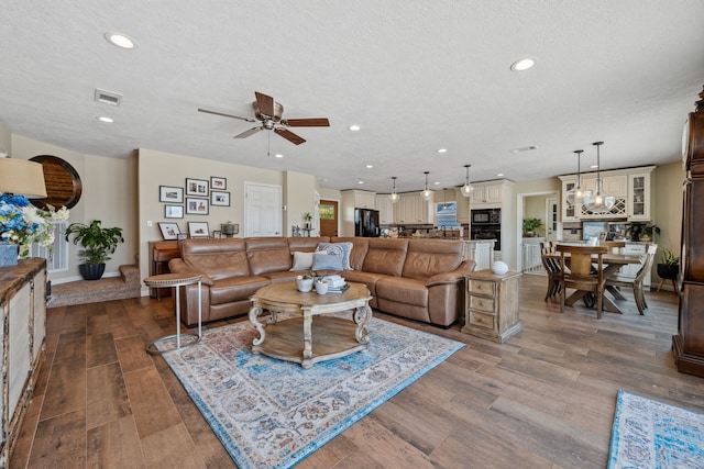 11320 Cedar Gully Rd, Beach City, TX 77523 - living area with wood finished floors, recessed lighting, a ceiling fan, and a textured ceiling