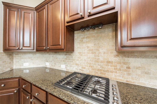 18219 S Austin Shore Dr, Cypress, TX 77433 - kitchen with stainless steel gas cooktop, backsplash, stone counters, and brown cabinetry