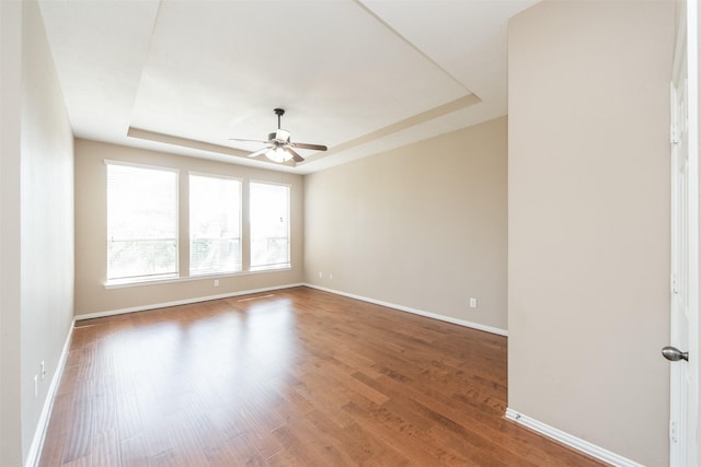 18219 S Austin Shore Dr, Cypress, TX 77433 - spare room featuring a raised ceiling, ceiling fan, and wood finished floors