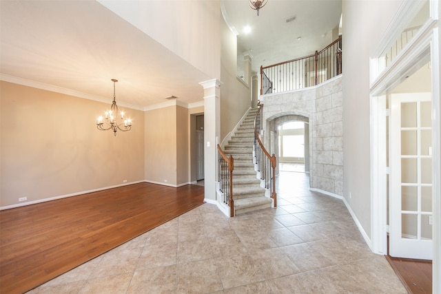 18219 S Austin Shore Dr, Cypress, TX 77433 - tiled foyer with stairway, a chandelier, a towering ceiling, ornamental molding, and arched walkways