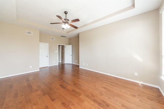 18219 S Austin Shore Dr, Cypress, TX 77433 - spare room featuring a raised ceiling, wood finished floors, and a ceiling fan