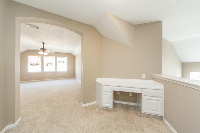 18219 S Austin Shore Dr, Cypress, TX 77433 - unfurnished office featuring lofted ceiling, ceiling fan, light carpet, arched walkways, and built in study area