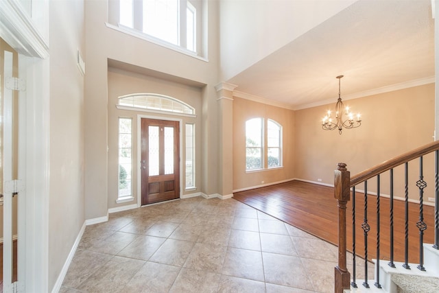 18219 S Austin Shore Dr, Cypress, TX 77433 - foyer entrance with a chandelier, stairs, ornamental molding, a towering ceiling, and light tile patterned floors