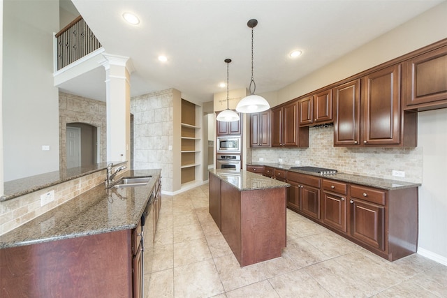 18219 S Austin Shore Dr, Cypress, TX 77433 - kitchen featuring appliances with stainless steel finishes, a kitchen island, dark stone countertops, light tile patterned flooring, and built in features
