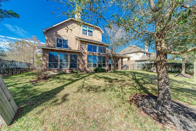 18219 S Austin Shore Dr, Cypress, TX 77433 - back of house with a fenced backyard, brick siding, and a chimney