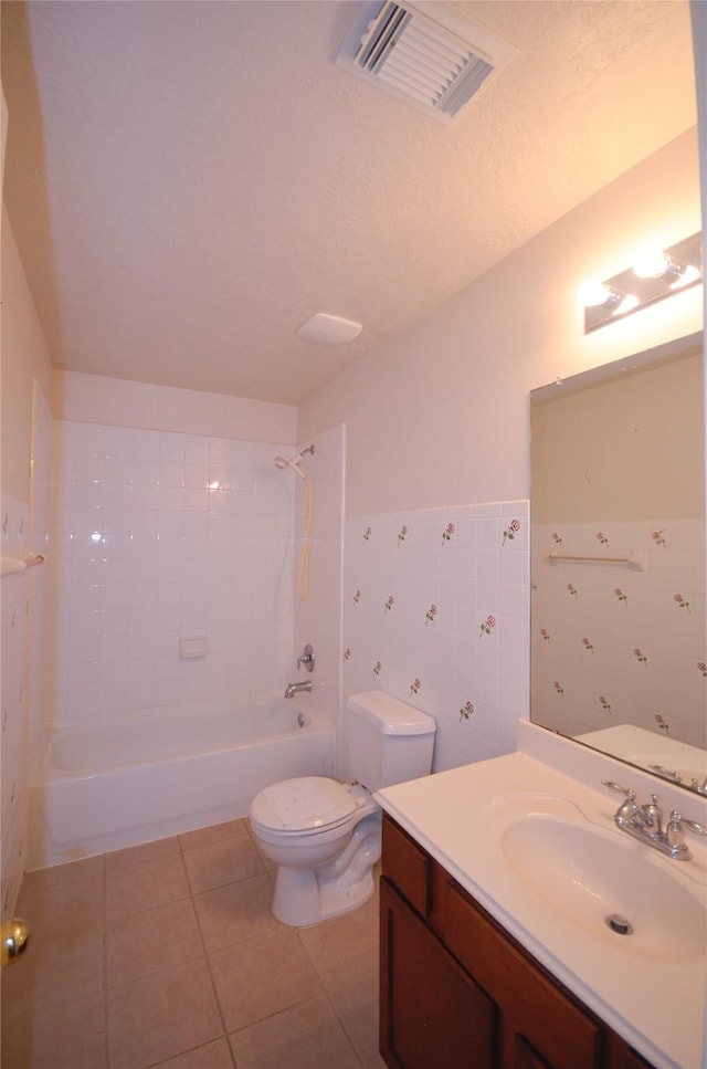 6906 Grant Dr, Magnolia, TX 77354 - bathroom with vanity, tile patterned flooring, shower / tub combination, tile walls, and wainscoting