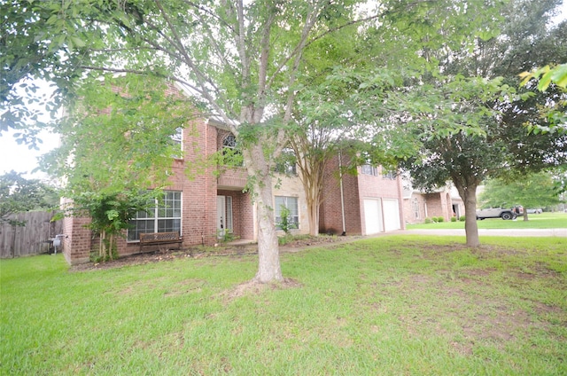 6906 Grant Dr, Magnolia, TX 77354 - obstructed view of property with an attached garage, concrete driveway, and brick siding