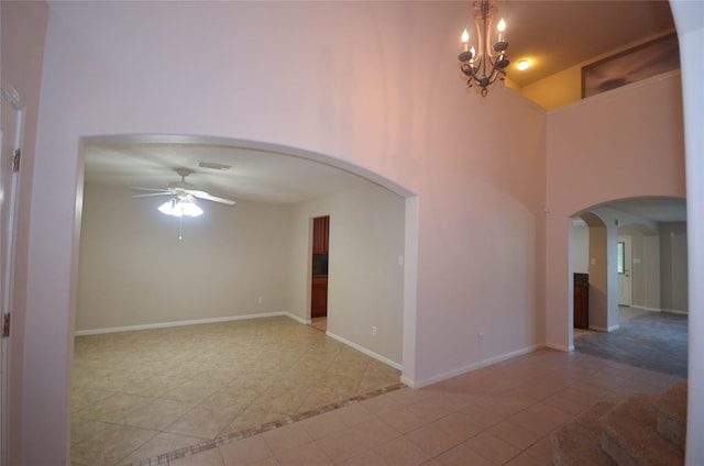6906 Grant Dr, Magnolia, TX 77354 - spare room with a ceiling fan, light tile patterned flooring, arched walkways, a chandelier, and a towering ceiling