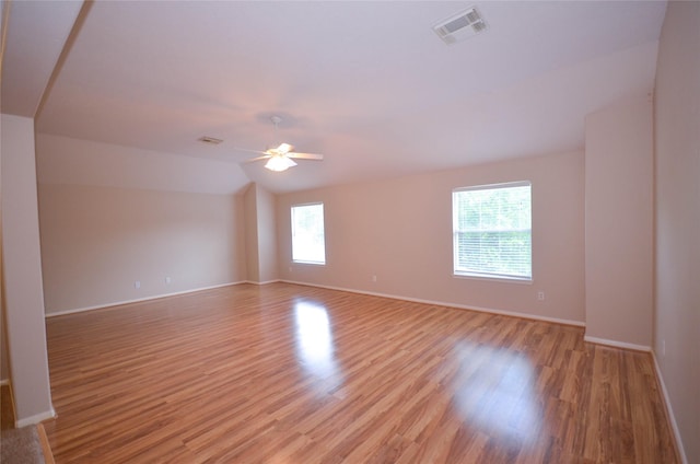 6906 Grant Dr, Magnolia, TX 77354 - spare room featuring light wood-style floors, a ceiling fan, and lofted ceiling