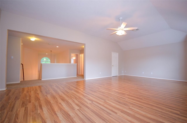 6906 Grant Dr, Magnolia, TX 77354 - unfurnished living room with a ceiling fan, light wood finished floors, and vaulted ceiling