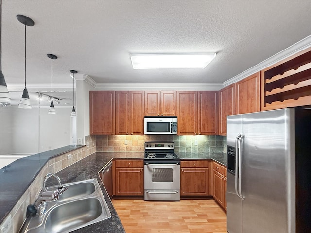 1711 Old Spanish Trl Unit 240, Houston, TX 77054 - kitchen featuring stainless steel appliances, brown cabinets, dark countertops, backsplash, and crown molding