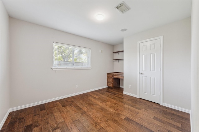 2826 Meadow Brook Ct, League City, TX 77573 - unfurnished bedroom with wood finished floors and built in desk