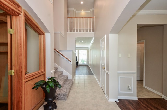 1501 Mulberry Ct, Pearland, TX 77581 - entryway featuring ornamental molding, stairs, light tile patterned floors, and arched walkways