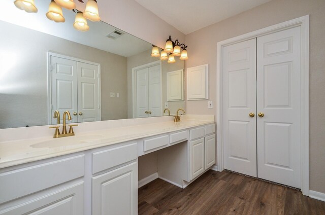 1501 Mulberry Ct, Pearland, TX 77581 - bathroom featuring double vanity and wood finished floors