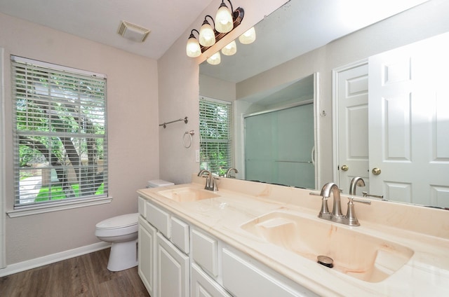 1501 Mulberry Ct, Pearland, TX 77581 - bathroom featuring wood finished floors, double vanity, and an enclosed shower