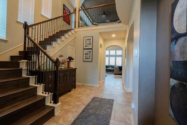 14907 Ashley Creek Ct, Humble, TX 77396 - entryway featuring arched walkways, a towering ceiling, plenty of natural light, and stairs