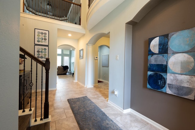 14907 Ashley Creek Ct, Humble, TX 77396 - entryway with arched walkways, stairs, tile patterned flooring, a high ceiling, and ornate columns