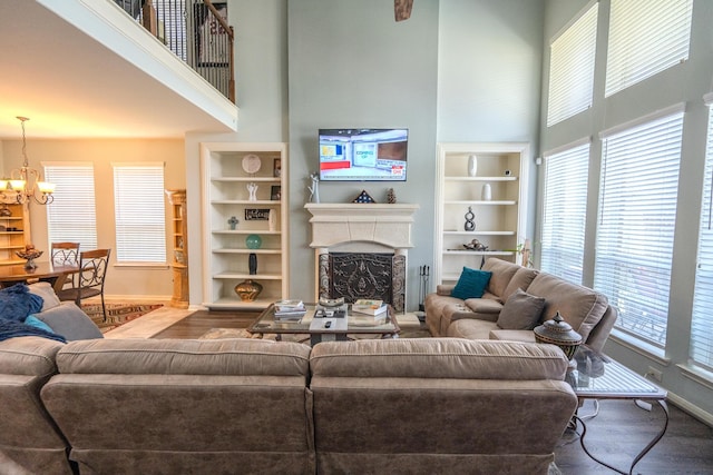 14907 Ashley Creek Ct, Humble, TX 77396 - living room with a high ceiling, a chandelier, plenty of natural light, a fireplace, and wood finished floors