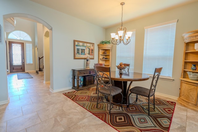 14907 Ashley Creek Ct, Humble, TX 77396 - dining space featuring arched walkways, healthy amount of natural light, a chandelier, and light tile patterned floors