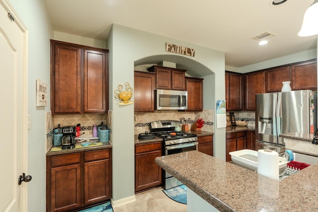 14907 Ashley Creek Ct, Humble, TX 77396 - kitchen featuring appliances with stainless steel finishes and decorative backsplash
