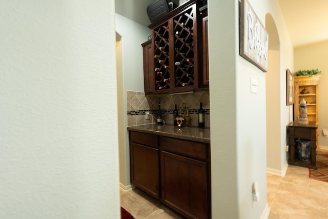 14907 Ashley Creek Ct, Humble, TX 77396 - indoor bar featuring backsplash, light tile patterned floors, and arched walkways