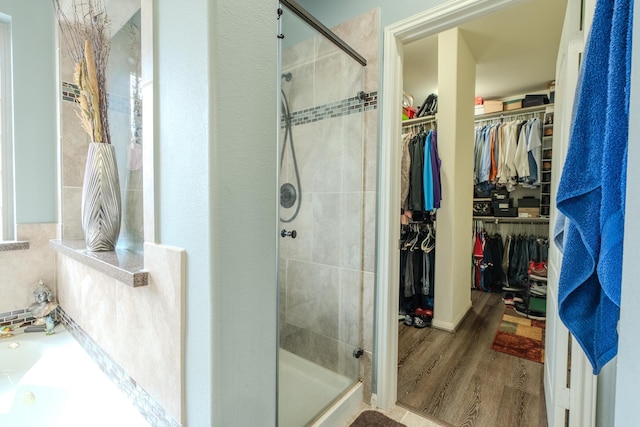 14907 Ashley Creek Ct, Humble, TX 77396 - full bath with a shower stall, wood finished floors, a bath, and a spacious closet