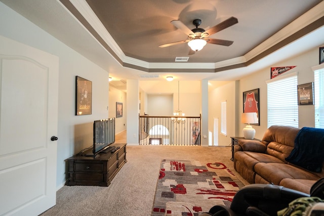 14907 Ashley Creek Ct, Humble, TX 77396 - living area with ornamental molding, carpet flooring, ceiling fan, a raised ceiling, and a chandelier