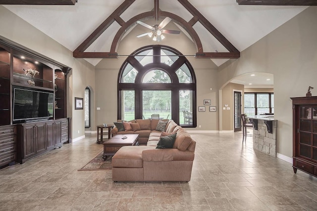 42015 Mill Creek Rd, Magnolia, TX 77354 - living area with arched walkways, high vaulted ceiling, a ceiling fan, stone tile flooring, and beamed ceiling
