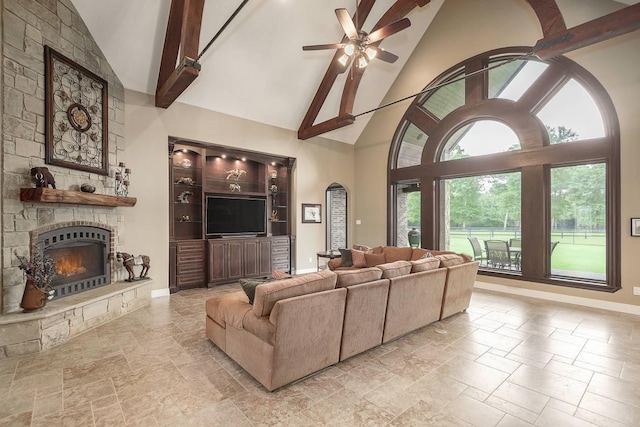 42015 Mill Creek Rd, Magnolia, TX 77354 - living area featuring high vaulted ceiling, a fireplace, stone tile floors, ceiling fan, and beamed ceiling