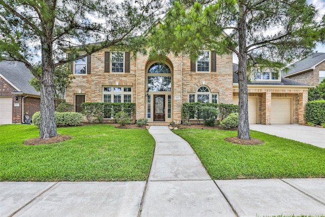 25827 Austin Spgs, Spring, TX 77373 - traditional home featuring driveway, a front yard, an attached garage, and brick siding