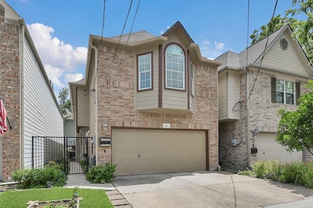905 Wakefield Dr, Houston, TX 77018 - view of front of home featuring concrete driveway, a garage, brick siding, and a gate