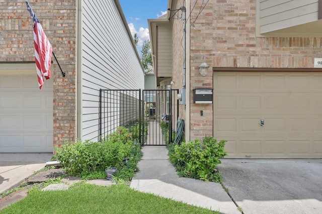 905 Wakefield Dr, Houston, TX 77018 - property entrance featuring a garage, brick siding, and a gate