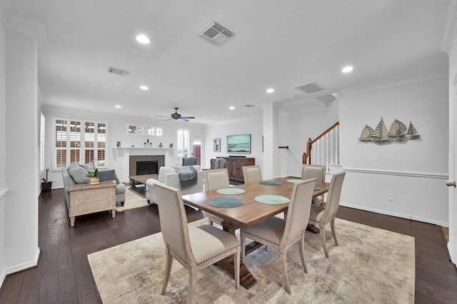 905 Wakefield Dr, Houston, TX 77018 - dining room featuring a fireplace, ceiling fan, recessed lighting, stairs, and dark wood-type flooring