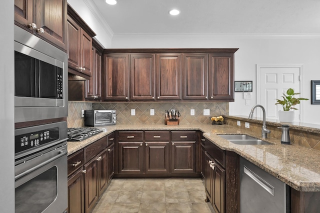 905 Wakefield Dr, Houston, TX 77018 - kitchen with stainless steel appliances, crown molding, tasteful backsplash, light stone countertops, and a peninsula