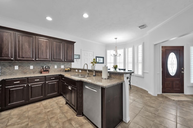 905 Wakefield Dr, Houston, TX 77018 - kitchen featuring dishwasher, a peninsula, dark brown cabinetry, a chandelier, and decorative backsplash