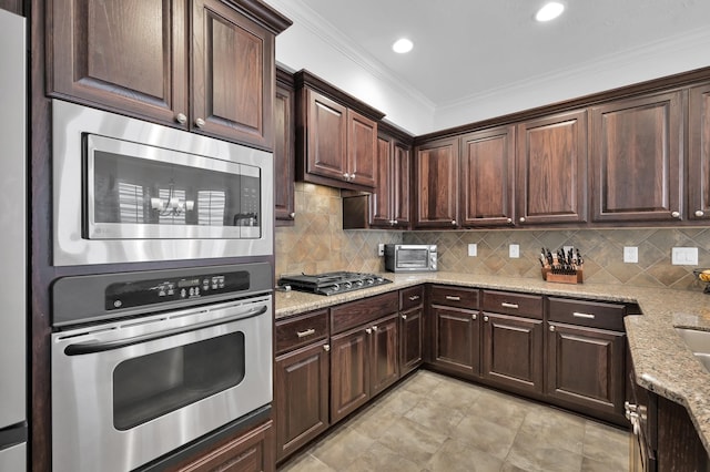 905 Wakefield Dr, Houston, TX 77018 - kitchen with stainless steel appliances, light stone counters, dark brown cabinets, ornamental molding, and decorative backsplash