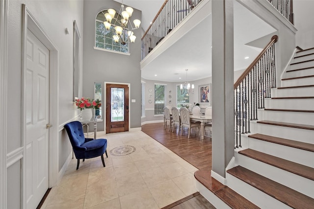 27115 Meadow Sage Ct, Cypress, TX 77433 - tiled foyer entrance with a chandelier, stairs, and a towering ceiling