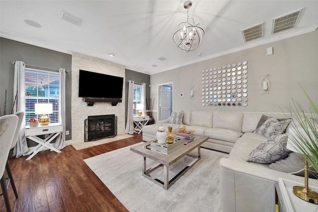 27115 Meadow Sage Ct, Cypress, TX 77433 - living area featuring ornamental molding, wood finished floors, a chandelier, and a fireplace