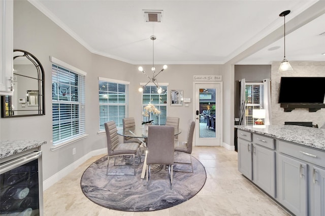 27115 Meadow Sage Ct, Cypress, TX 77433 - dining space with beverage cooler, light tile patterned flooring, a chandelier, and ornamental molding