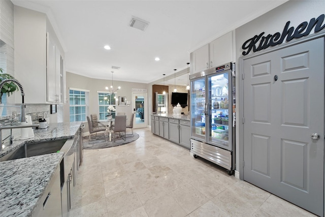 27115 Meadow Sage Ct, Cypress, TX 77433 - kitchen with a chandelier, light stone counters, tasteful backsplash, recessed lighting, and hanging light fixtures