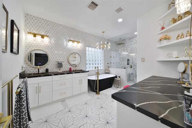 27115 Meadow Sage Ct, Cypress, TX 77433 - bathroom with a stall shower, double vanity, a freestanding tub, a chandelier, and tasteful backsplash