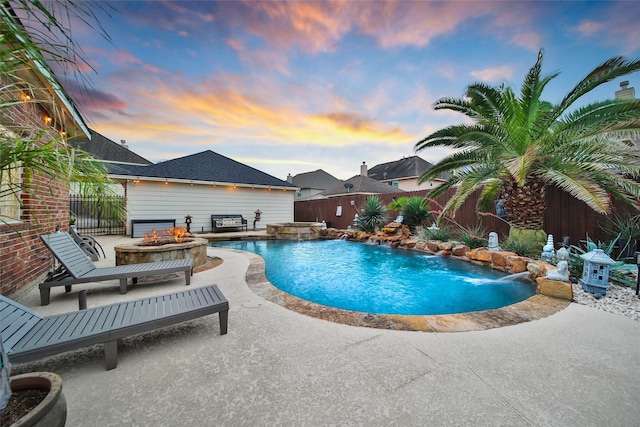 27115 Meadow Sage Ct, Cypress, TX 77433 - pool at dusk with a fire pit, a fenced backyard, a patio area, and a pool with connected hot tub