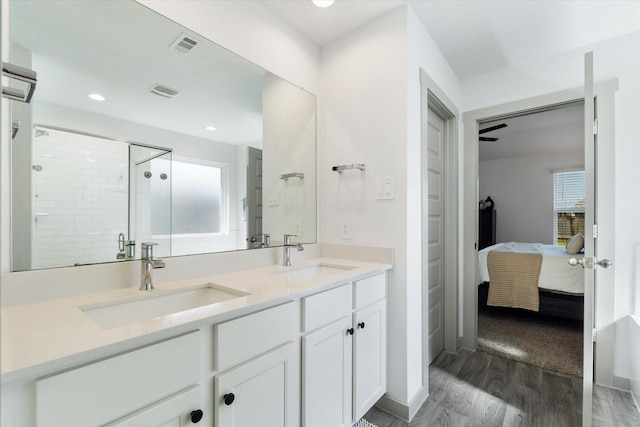 14906 Rain Tree Dr, Baytown, TX 77523 - full bath featuring ensuite bathroom, wood finished floors, double vanity, a stall shower, and recessed lighting