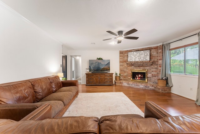 25607 Spring Ridge Dr, Spring, TX 77386 - living area featuring wood finished floors, ceiling fan, ornamental molding, and a fireplace