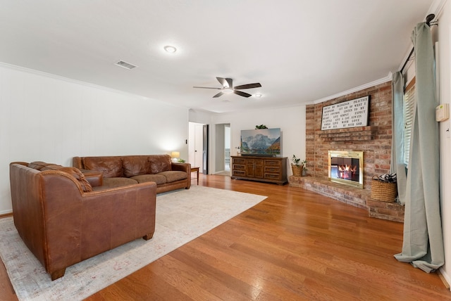 25607 Spring Ridge Dr, Spring, TX 77386 - living area with ceiling fan, wood finished floors, a fireplace, and crown molding