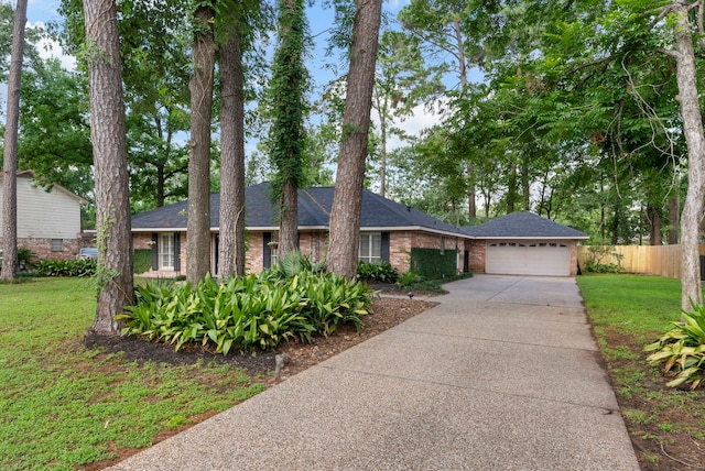 25607 Spring Ridge Dr, Spring, TX 77386 - ranch-style house featuring a garage, driveway, brick siding, and a shingled roof