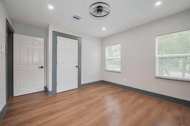 6058 Lyndhurst Dr, Houston, TX 77033 - unfurnished bedroom with light wood-style floors and recessed lighting