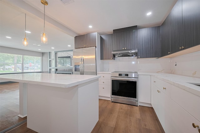 6058 Lyndhurst Dr, Houston, TX 77033 - kitchen featuring stainless steel appliances, under cabinet range hood, a center island, wood finished floors, and recessed lighting